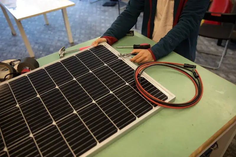 Solar technician inspecting and assembling a residential solar panel